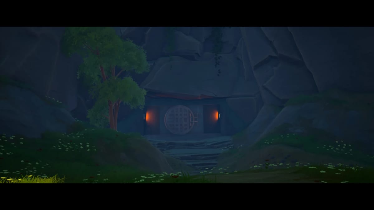 The cave entrance at night: a circular latticed door set into a rock face, lit only by two warm lamps either side of it, with a tree and grass in cool blue shadow.